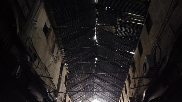 moving through dark alley (Suq Al Hamidiyah) looking up on old roof construction