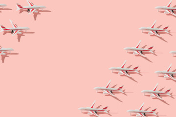 Airplanes minimal pattern with sunlit shadows on bright peach pink colored background. Trendy travel concept. Vacation creative idea. Copy space.
