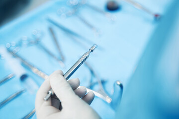 Person holding electrosurgical pencil tool over table