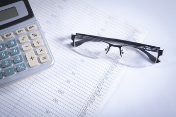 Close up calculator and financial report - accounting concept