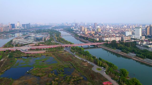 aerial view of modern cityscape along river in midtown of jinhua
