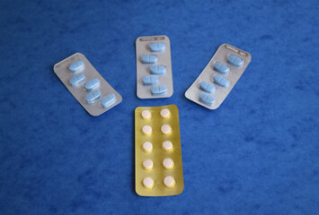 packs of pills isolated on blue background