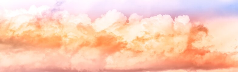 Panorama of twilight sky with effect of light pastel pink colors. Colorful sunset of soft clouds.