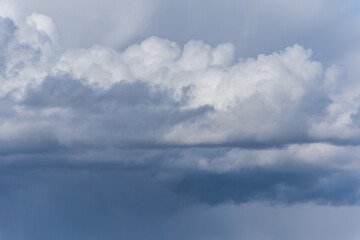 Fototapeta na wymiar Gray overcast cloudy sky over horizon. Closeup clouds