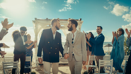 Handsome Gay Couple Walking Up the Aisle at Outdoors Wedding Ceremony Venue Near Ocean. Two Happy...