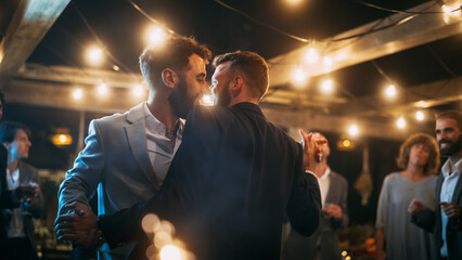 Handsome Happy Gay Couple Celebrate Wedding at an Evening Reception Party with Diverse Multiethnic...