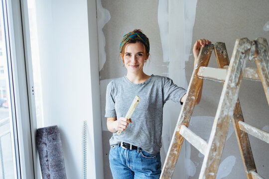Young woman renovating her bedroom