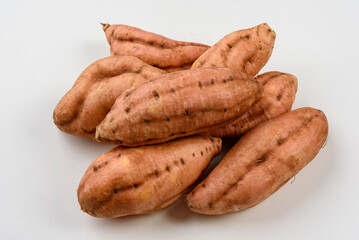 Sweet carrot potatoes isolated on white background.