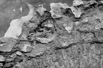 Old grungy retro dirty faded brick wall of ancient city. Uneven pitted peeled surface brickwork of cellar worn. Cracked shabby clay blocks. Hard bumpy messy ragged holes brickwall of 3D grunge design