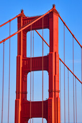Detail of top of Golden Gate Bridge with vibrant sunset reds
