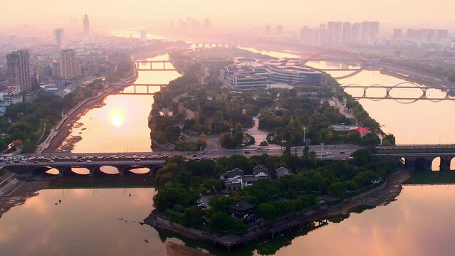 aerial view of modern cityscape along river in midtown of jinhua at sunset

