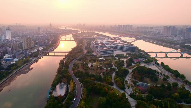 aerial view of modern cityscape along river in midtown of jinhua at sunset
