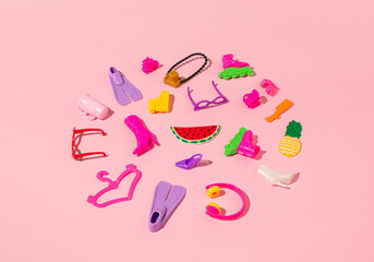 The creative layout is made of women's accessories on pink background. Minimal summer travel concept. Pop art.