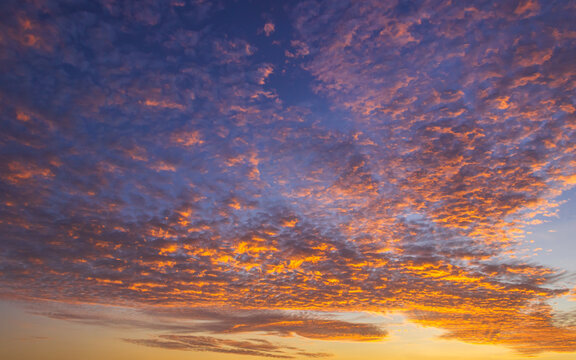 Colorful sunset sky in the morning with yellow, orange sunrise clouds fluffy 