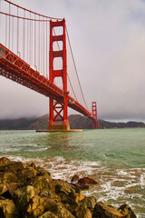 Foggy morning at Golden Gate Bridge from southeast rocky coast in bay