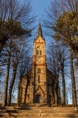 Fototapeta na wymiar Religious architectural style, soaring arches, a tall spire, and a traditional cruciform shapeTorņakalns Church in Riga, Latvia, Europe during early spring evening. Neo-gothic Lutheran church