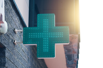Pharmacy green light cross board. Drugstore signboard on building. Store decoration of downtown....
