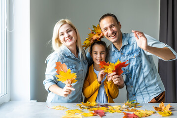 Fototapeta premium family At Home Doing Craft And Making Picture From Leaves In Kitchen