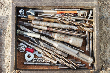 a set of metal drills of different diameters in a box