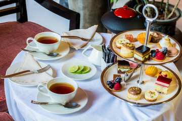Tea table with desserts, Photo is selective focus with shallow depth of field.