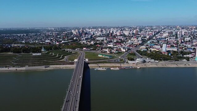 Embankment and river port of the city of Barnaul on the Ob River, view from a great height of the Siberian city in summer