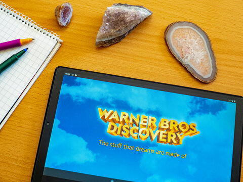 In This Photo Illustration Warner Brothers Discovery Logo Seen Displayed On A Tablet