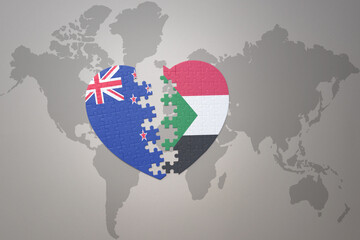 puzzle heart with the national flag of new zealand and sudan on a world map background. Concept.