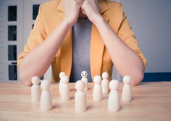 HR or human resource management concept. Young woman in yellow suite choice of an employee leader from the crowd. A businesswoman choose employees for her work. Pink background.