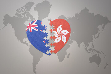 puzzle heart with the national flag of new zealand and hong kong on a world map background. Concept.
