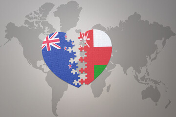 puzzle heart with the national flag of new zealand and oman on a world map background. Concept.
