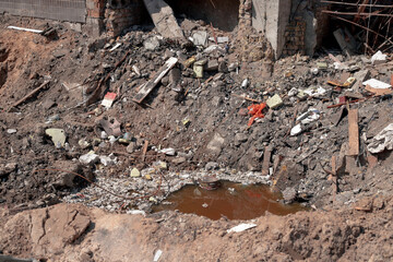 Explosion of an air bomb near the entrance of a residential building. A large crater from an aerial...