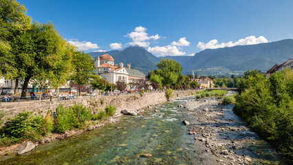 Merano (or Meran) is a city surrounded by mountains near Passeier Valley and Val Venosta (South Tyrol, Italy). The Passer river flows through Merano. It's a popular among famous artists and scientists - obrazy, fototapety, plakaty