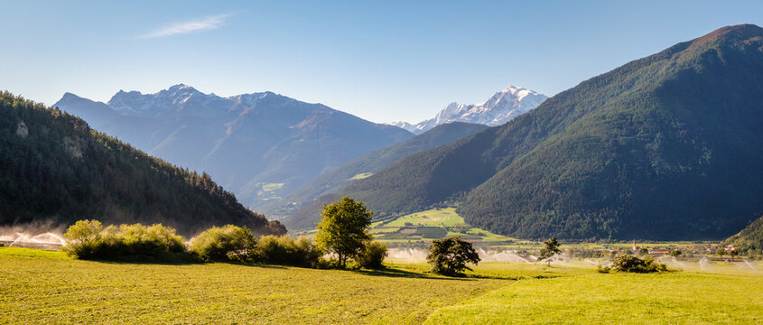 The mighty Ortler Mountain Group in the Val Venosta (South Tyrol, Italy). It is the heighest mountain in the Eastern Alps outside the Bernina Range. Sprinklers moisten the land.
