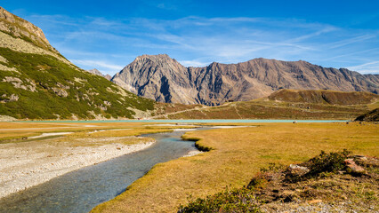 Walking along the largest lake in the &Ouml;tztal Alps, beautiful Lake Rifflsee. It is located close to the Kaunergrat Nature Park above the Pitztal Valley, surrounded by &Ouml;tztal Alps and Kaunergrat peaks.