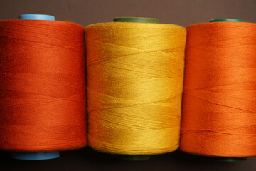Colorful thread spool background, close-up