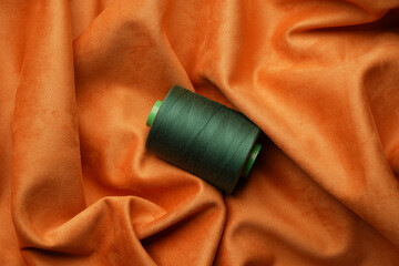 Green thread spool background, close-up