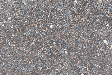 Gray small rocks ground texture. black small road stone background. gravel pebbles stone seamless texture. dark background of crushed granite gravel, close up. clumping clay.