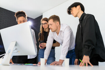 A multinational team works in the office