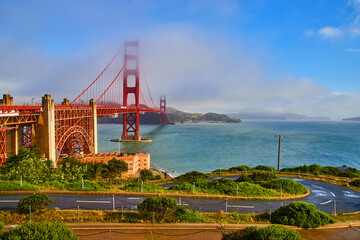 Fog going through vibrant Golden Gate Bridge in San Francisco