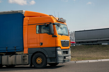 The truck is moving along a suburban highway. Cargo transportation, logistics.