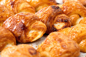 Tasty freshly baked buns on the bakery counter
