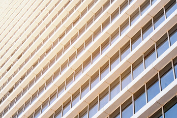 Windows of a modern business office building lit by sun rays