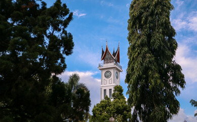 Fototapeta na wymiar Jam Gadang is a clock tower that is a marker or icon for the City of Bukittinggi, West Sumatra, Indonesia. This clock tower has a clock with a large size on four it is called the Clock Tower.