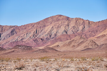 Fototapeta na wymiar Desert red and tan mountains in early spring