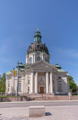 The church Gustaf Vasa Kyrka at the square Odenplan with Swedish and Ukraina flags a sunny summer ...