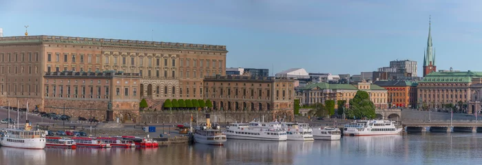 Fotobehang Pier with commuter boats and tourist boats at the slope Slottsbacken, the castle and the old town Gamla Stan a sunny summer day in Stockholm © Hans Baath