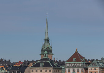 Fototapeta na wymiar Tin roofs, dorms and the German church in the old town Gamla Stan a sunny summer day in Stockholm