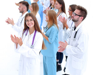 Fototapeta premium side view. a group of applauding doctors looking at the camera