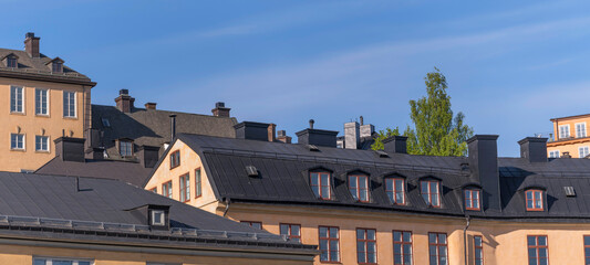 Old houses on a hill in the district Södermalm tin roofs and dorms a sunny summer day in Stockholm