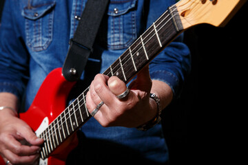 Fototapeta premium elderly man plays the electric guitar